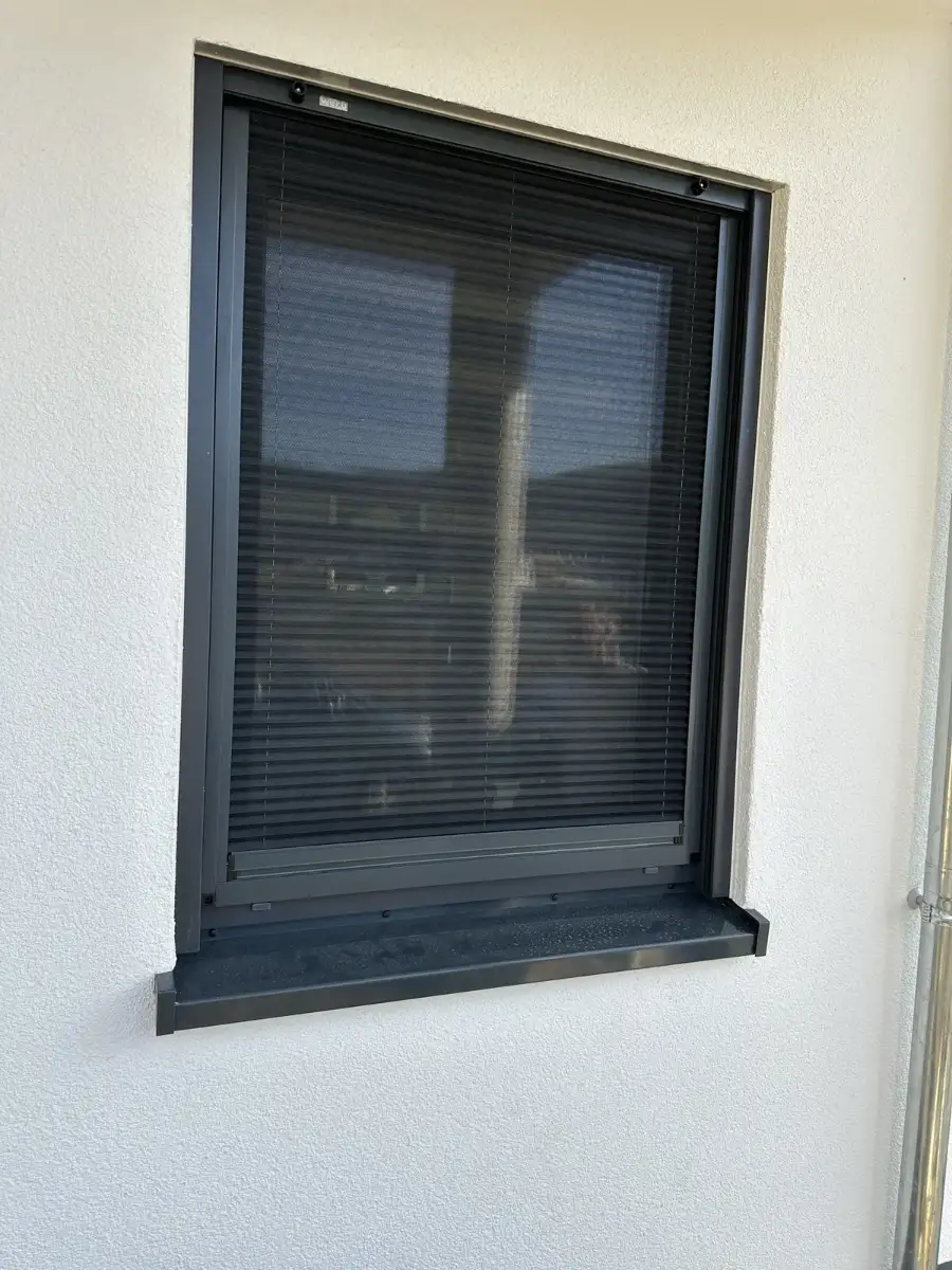 Fenster in weiß verputzter Fassade mit sauberer Laibung